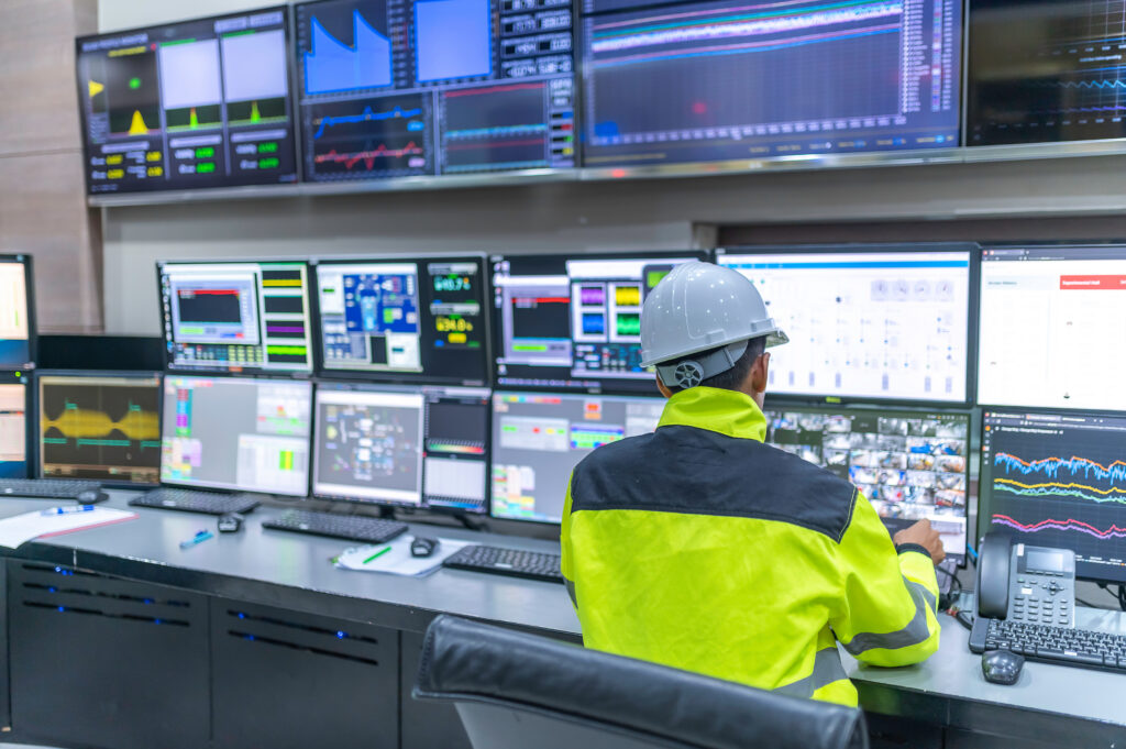 Image of an Engineer working at control room,Manager control system,Technician man monitoring program from a lot of monitor