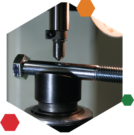 Image of a screw getting tested for quality.